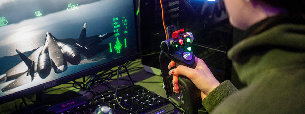 A girl plays a military flight simulator computer game inside the Russian Defence Ministry pavilion at Russia Expo, Moscow.