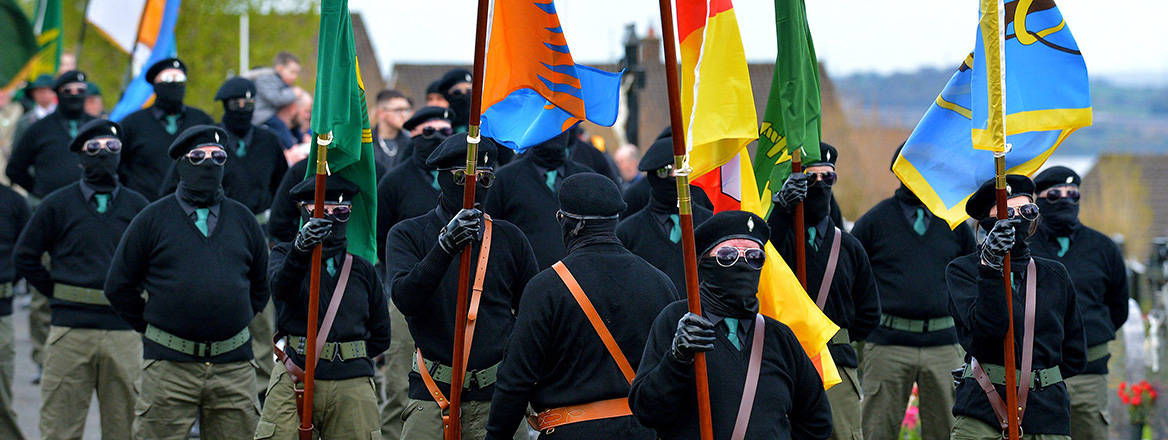Masked men and women in paramilitary uniform at an Easter Monday Dissident Republican parade in Derry, Northern Ireland.