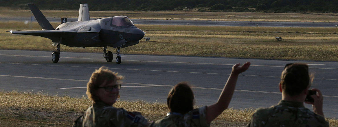Soldiers wave at a F-35B aircraft landing at Akrotiri RAF base near Limassol, Cyprus.