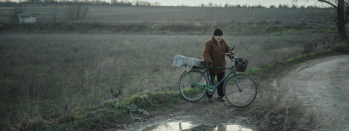 A Ukrainian famer pushes his bicycle on his way home to a village that was occupied by Russian forces.