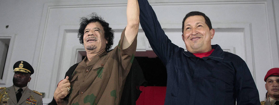 Libyan leader Moammar al-Gaddafi raised hands with Venezuelan President Hugo Chavez in Margarita Island, Venezuela, 28 September, 2009. The two sides had signed a joint declaration to further political, economic and energy cooperation.