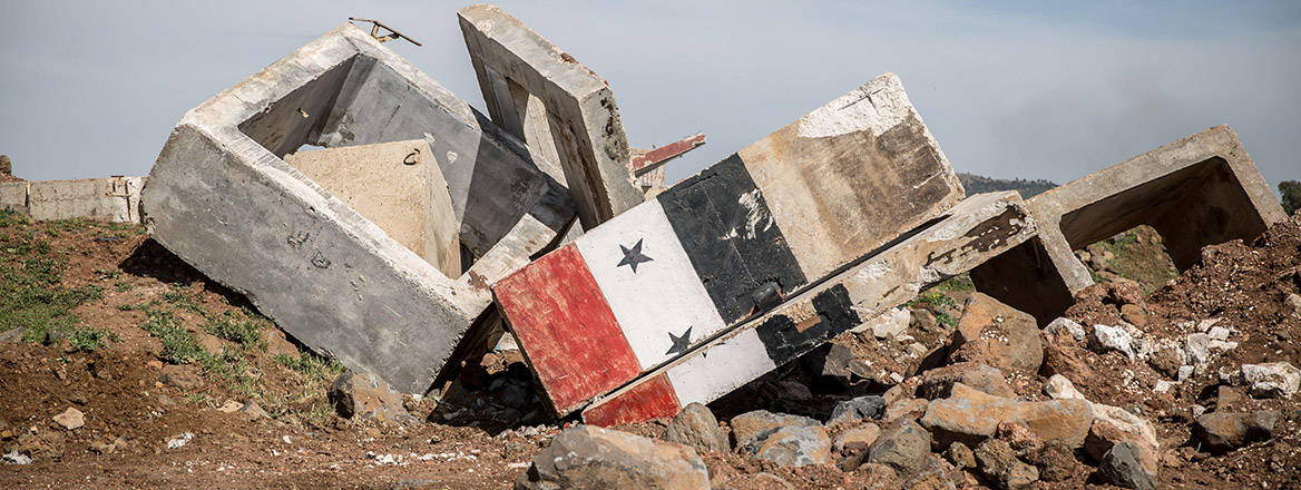 The site of what reportedly used to be a Russian military base in Al-Nasiriya, southern Syria, said to have been destroyed by Israeli soldiers in the week running up to 28 March 2025. A Syrian flag is painted across one demolished wall. 