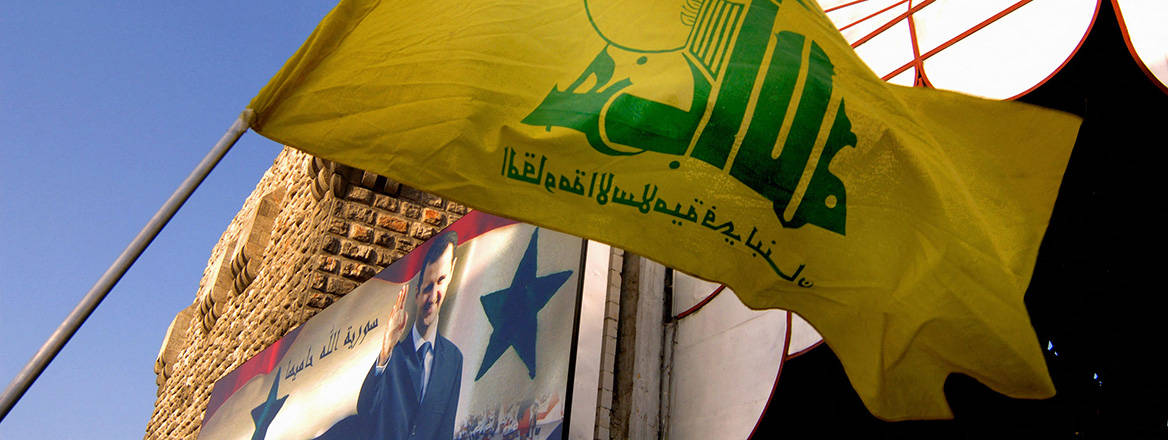 Hezbollah flag and a poster of Bashar Al Assad at Hamadiyya souk in Damascus, Syria.