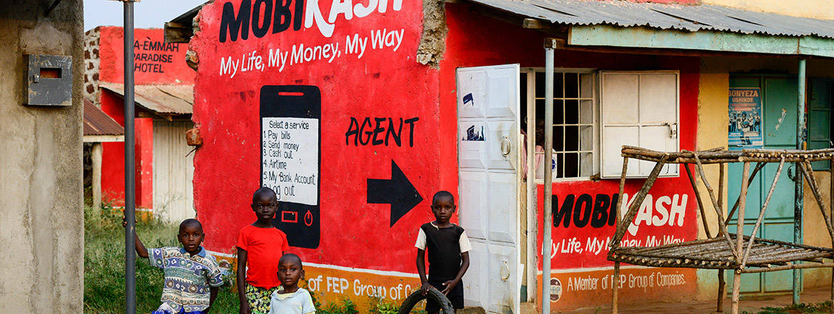 A painted advertisement for a mobile money agent on the wall of a building in the village of Kotanega in Kenya.