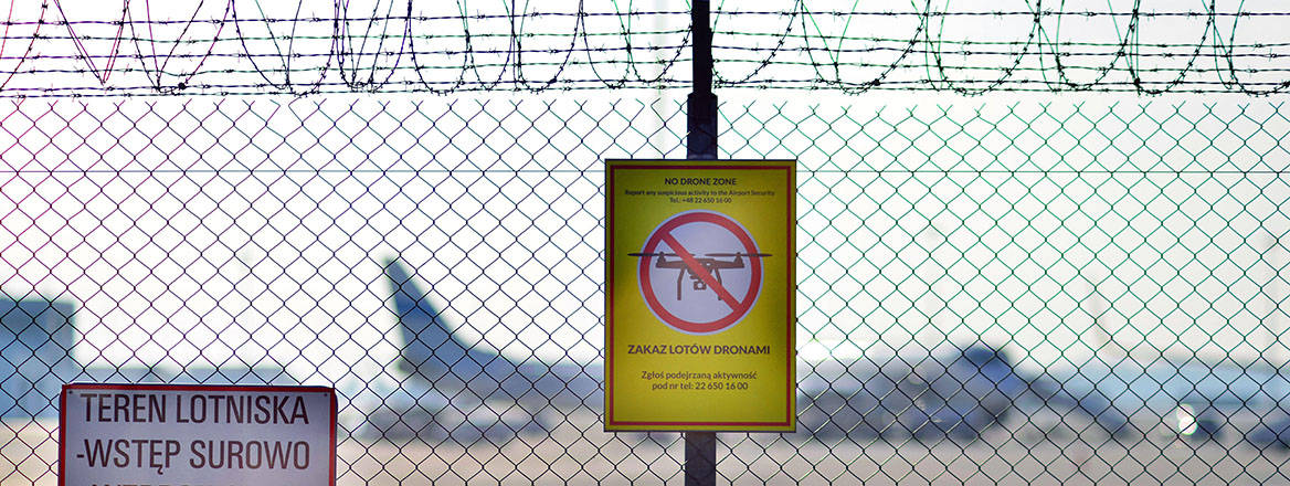 No drone flying sign at the perimeter fence netting of Chopin Airport airspace, in Warsaw, Poland.
