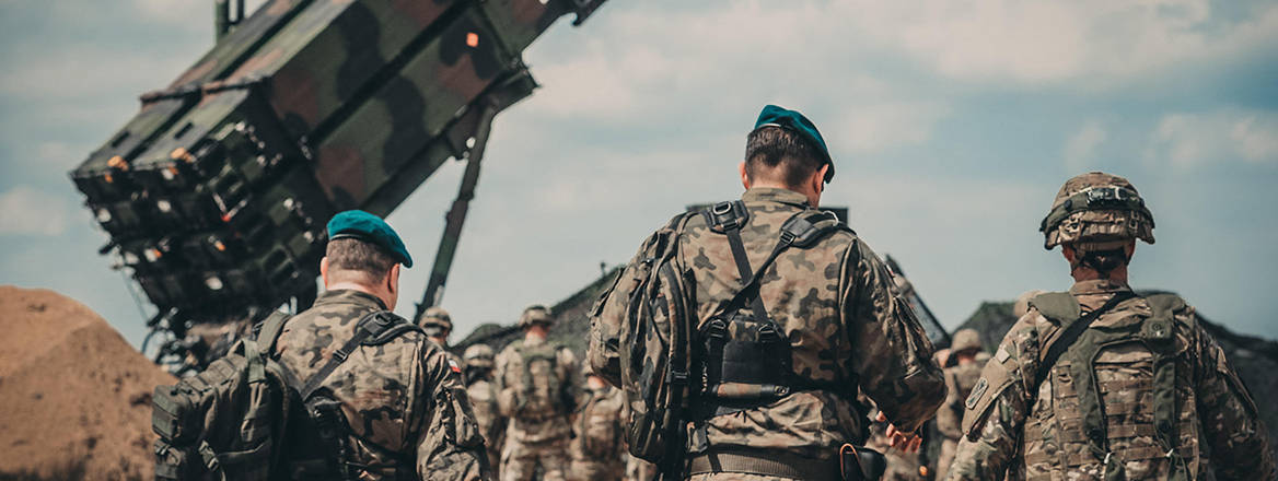 Service members from the US Army and the Polish Land Forces walk to the site of a Patriot missile system for a verbal demonstration of its operation and capabilities near Drawsko Pomorskie, Poland.