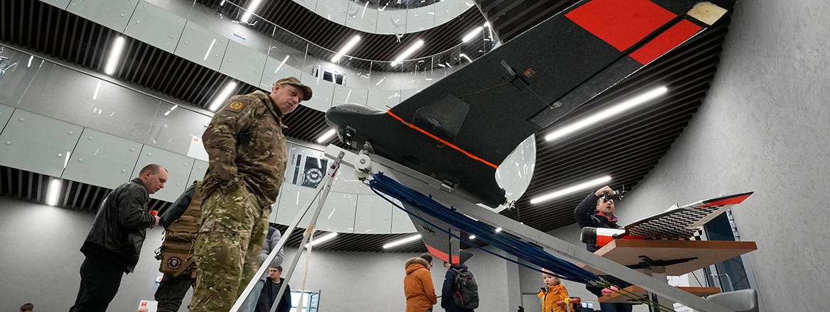 Visitors examine unmanned aerial vehicles in the 'PMC Wagner Centre',  St. Petersburg, Russia, 4 November, 2022.