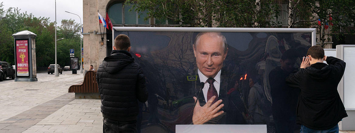 Workers set up a billboard of Russian President Putin, as part of the out-the-door exhibition on Tverskoy blvd, Moscow, Russia.