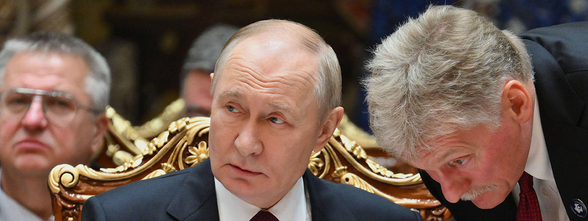 Russian President Vladimir Putin speaks with Kremlin Spokesman Dmitry Peskov during the summit of the Commonwealth of Independent States at the Palace of the Nation in Dushanbe, Tajikistan.