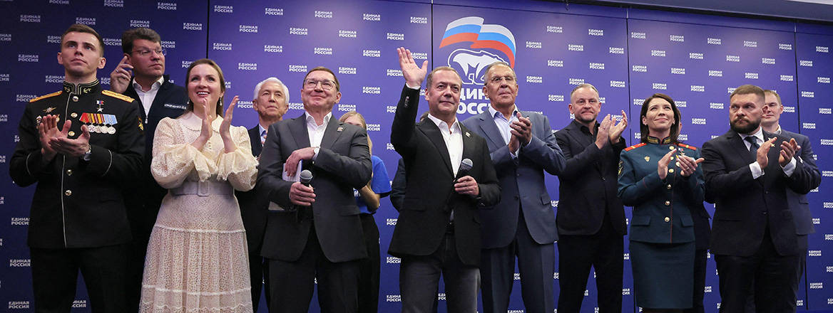 Russian Security Council Deputy Chairman and the head of the United Russia party Dmitry Medvedev, center, and Russian Foreign Minister Sergey Lavrov, center right, stand with other party members as they watch preliminary voting results for Russian parliamentary elections at the United Russia's headquarters in Moscow, Russia, Sunday, Sept. 20, 2026.
