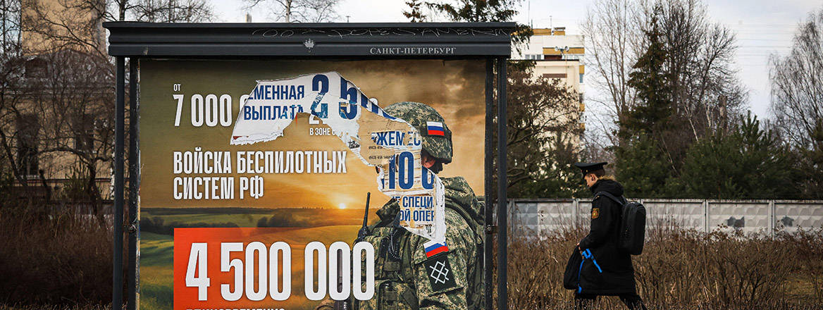 A defaced information billboard advertising contract service in the Russian Armed Forces, St. Petersberg, Russia.