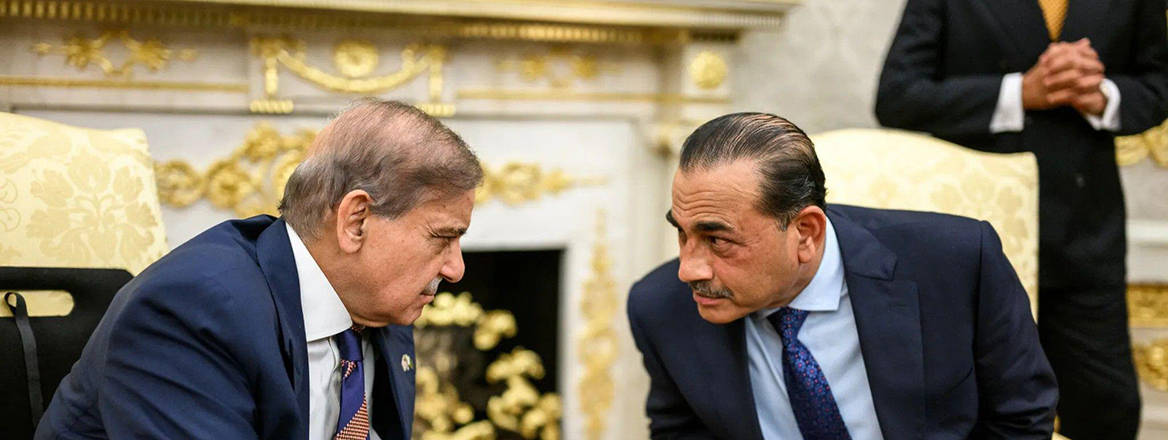 Prime Minister Shehbaz Sharif of Pakistan speaks with Field Marshal Asim Munir during a meeting at the White House.