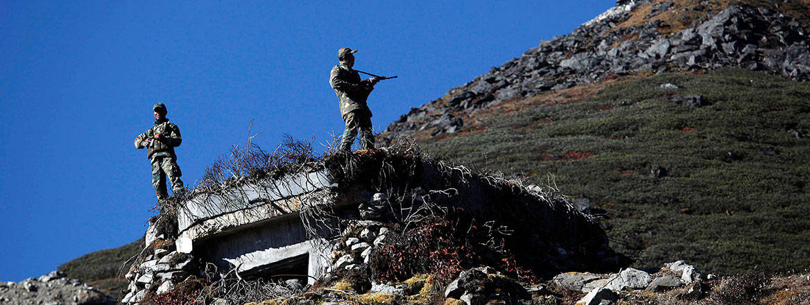 Indian soldiers keep watch at the India–China border in Bumla in Arunachal Pradesh, India, October 2012. Courtesy of Associated Press/Alamy