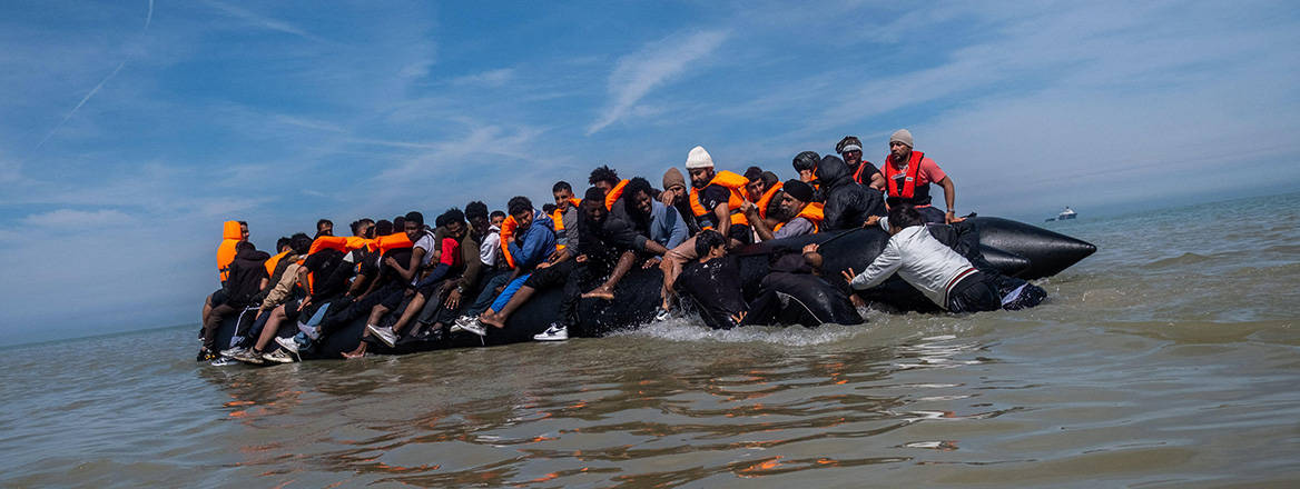 People thought to be migrants board a small boat off the coast of Berck, France, during an attempt to cross the English Channel.