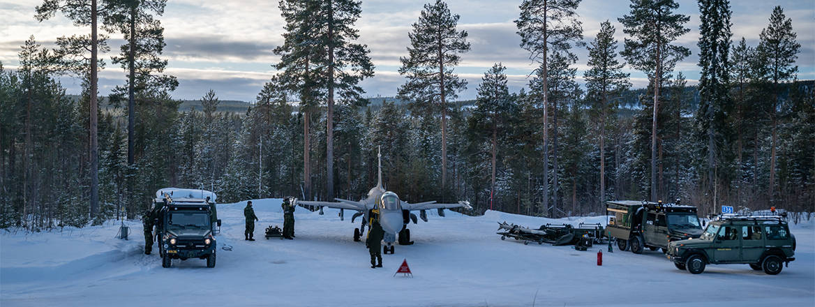 Swedish conscript mechanics re-arm a JAS-39C Gripen between sorties at a remote dispersal airstrip, 1 February 2023