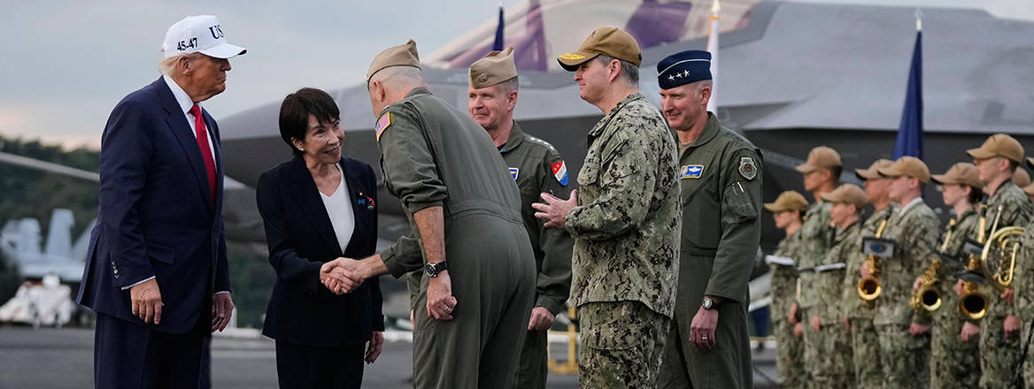 Japanese Prime Minister Sanae Takaichi, with President Donald Trump, is greeted by U.S. navy personnel aboard the USS George Washington, an aircraft carrier docked at a US naval base, in Yokosuka.