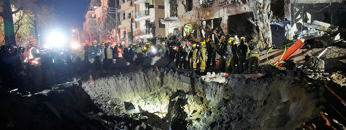 Officers from Israel's Home Front Command search through the rubble of a damaged apartment building after an Iranian missile strike, in Tel Aviv, Israel, early 1 March, 2026.