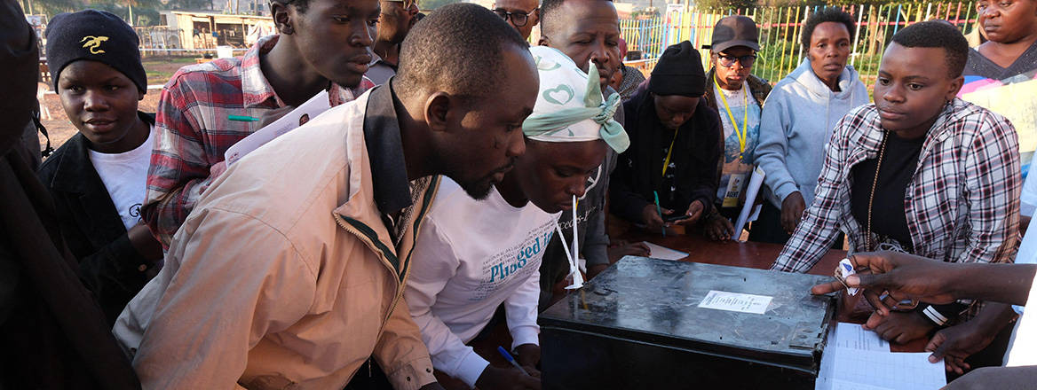 Polling agents witness the unsealing of a ballot box at a polling station in Kampala, Uganda, in the 2026 elections.
