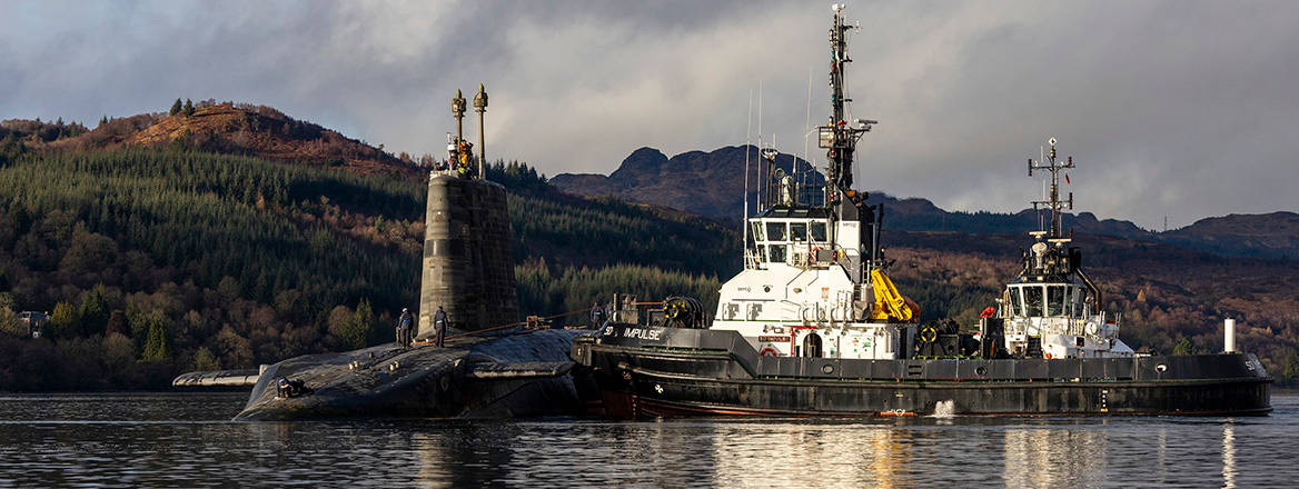 The vanguard class nuclear submarine, HMS Vengeance navigates through Gare Loch as she departs HM Naval Base Clyde in Faslane to conduct sea trials.