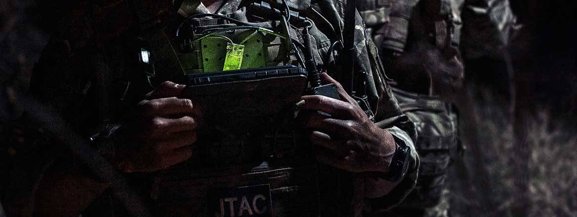 A handheld British Army controller at night.