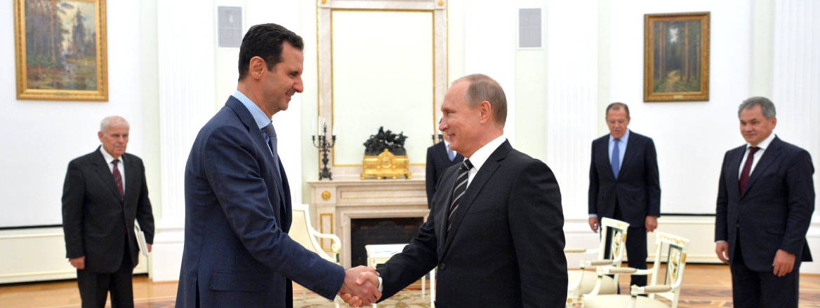 Assad shaking hands with Putin