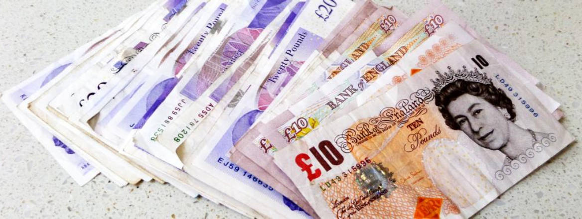 British pound notes on table