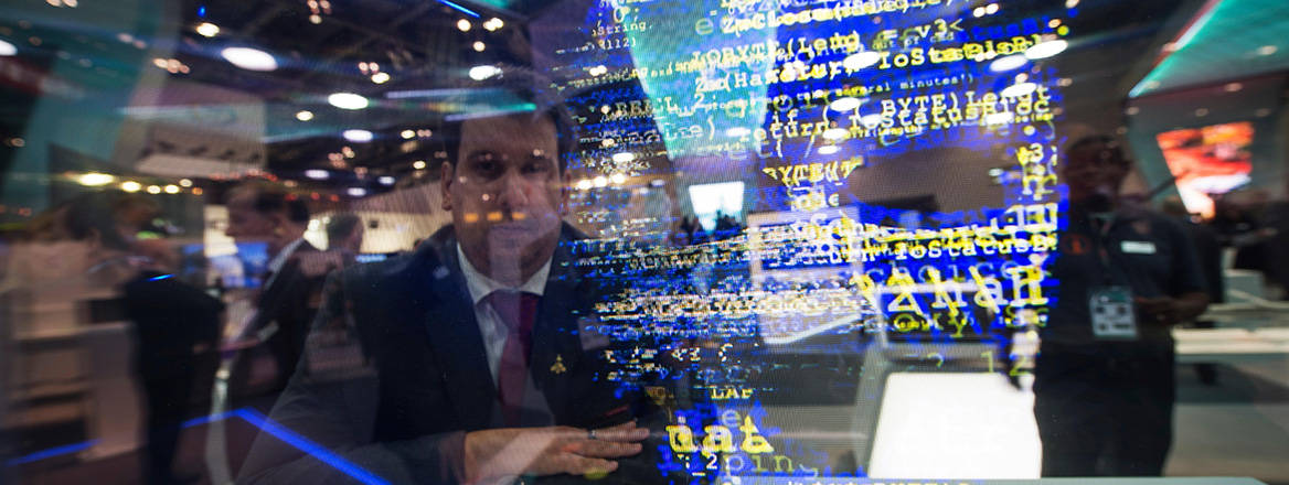 A delegate watches a presentation on terrorism, hacking and state-sponsored espionage at the Defence and Security Equipment International (DSEI).