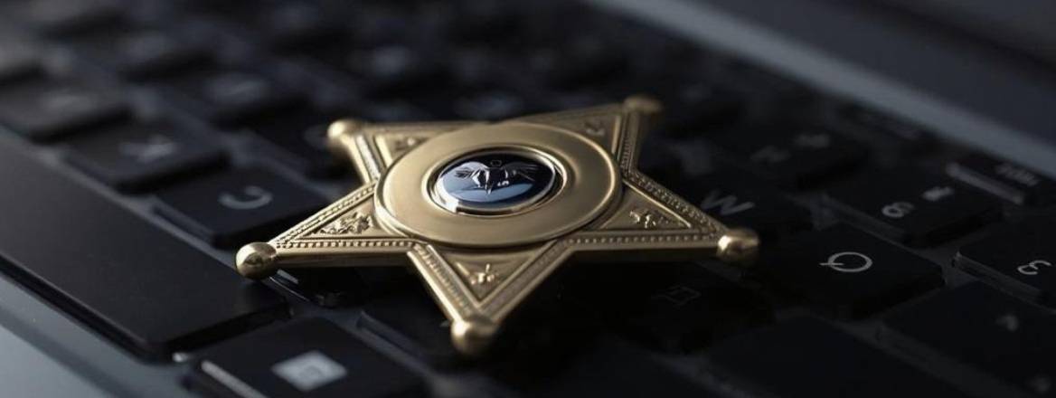 Image of deputy badge portrayed on a keyboard. 