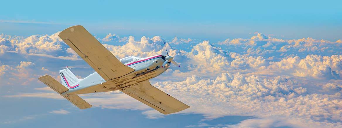 An elegant plane flies through a blue sky.