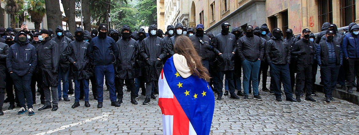 European dream: a demonstrator stands in front of police outside Georgia's parliament building in Tbilisi in May 2024