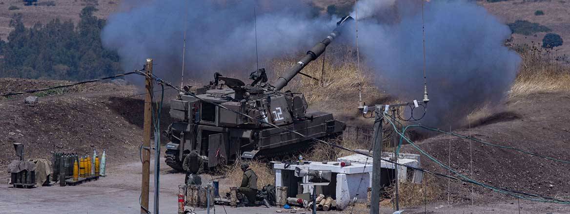 Israeli military asset shortly after firing. The foreground is concrete with some poles; the background is forest and plains
