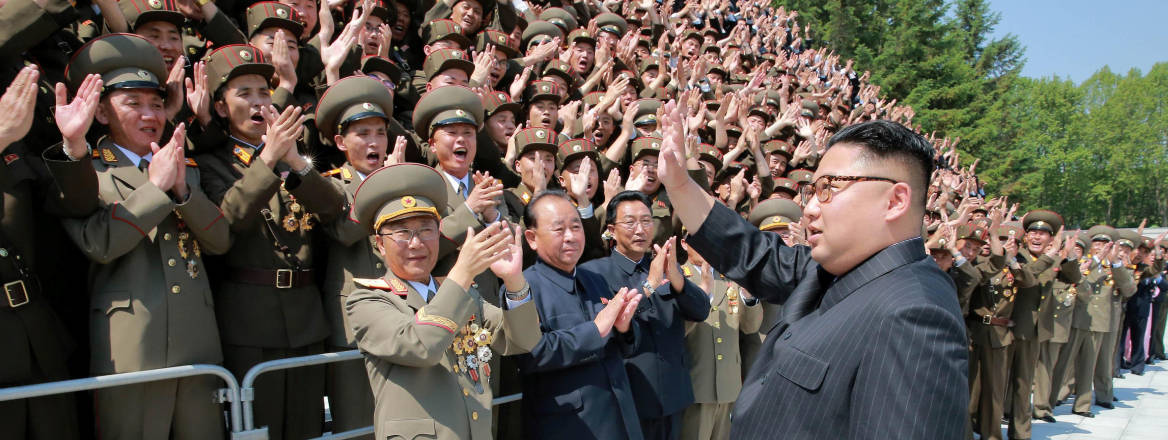 Kim Jong Un waving to scientists