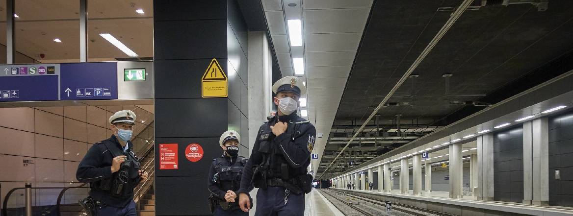 workers wearing mask on a train station platform