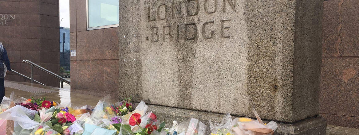 flowers at London bridge stone plaque