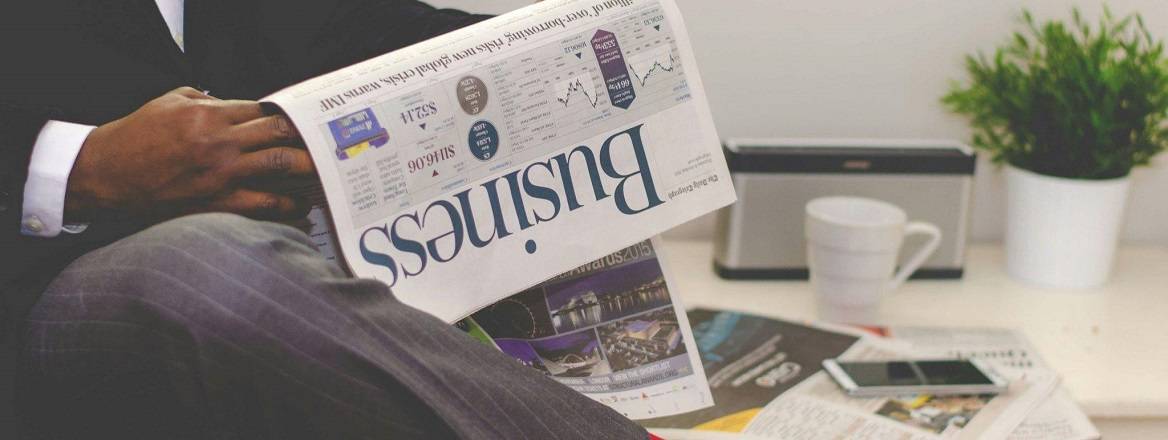 Man reading the business section of a newspaper