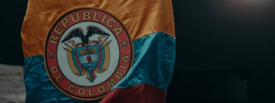 A man stands veiled in flag of the Republic of Colombia