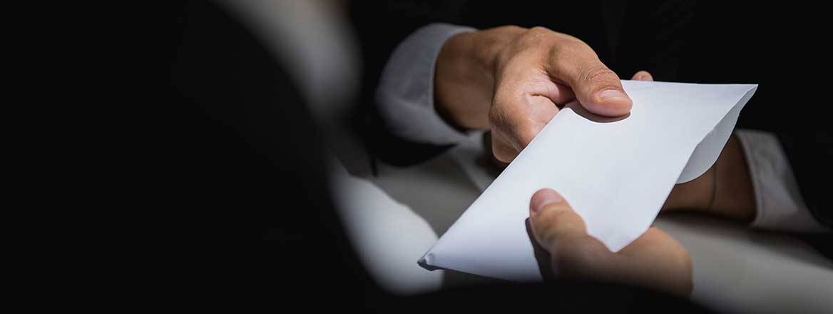 Man hands money over in an envelope