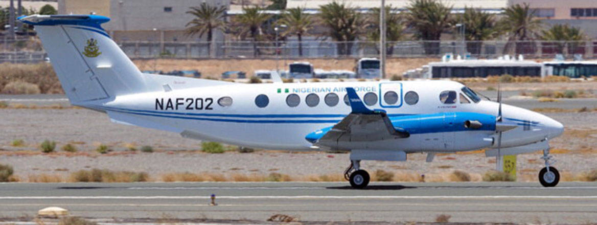 A small light aircraft of the Nigerian air force, on a runway