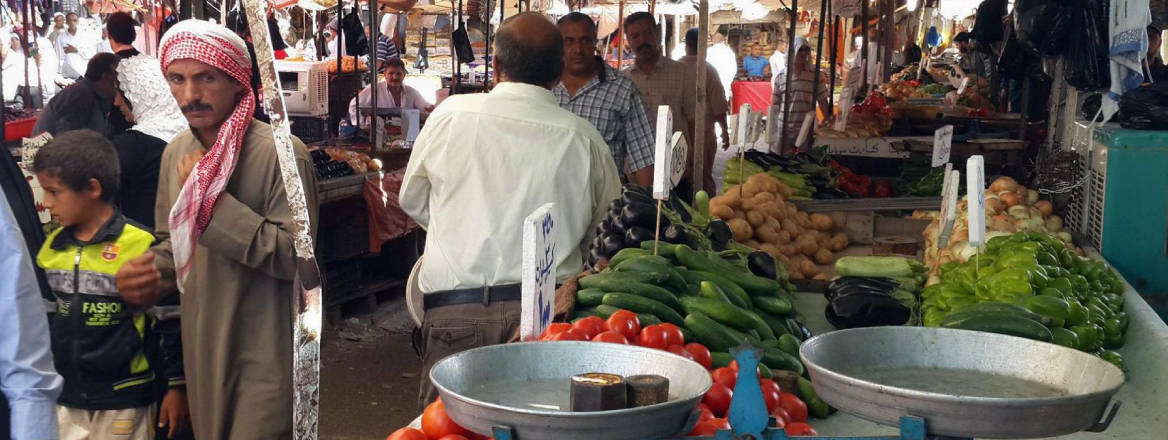 people shop at market in Mosul in Iraq