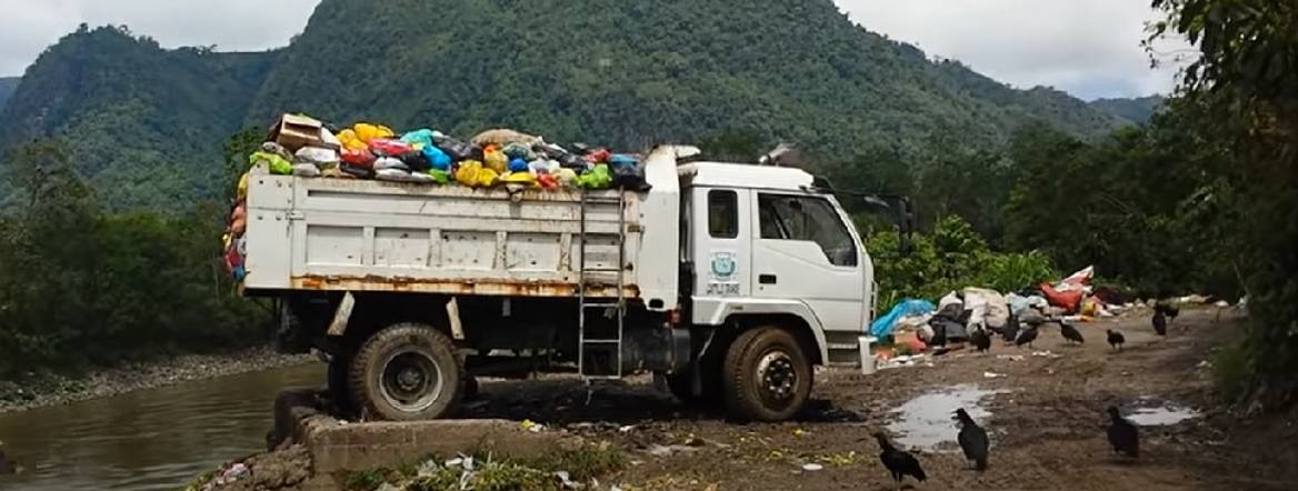 rubish truck dumping into the amazon
