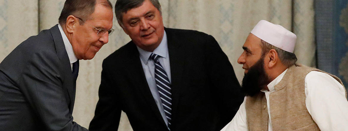 Russian Foreign Minister Sergei Lavrov welcomes a member of the Taliban delegation during talks on Afghanistan in Moscow in November 2018
