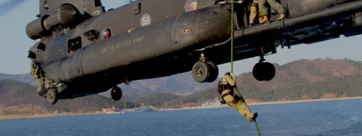 SEALS going down rope off helicopter