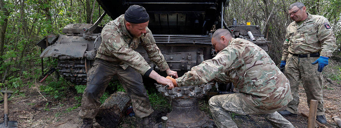 Three servicemen undertaking repairs