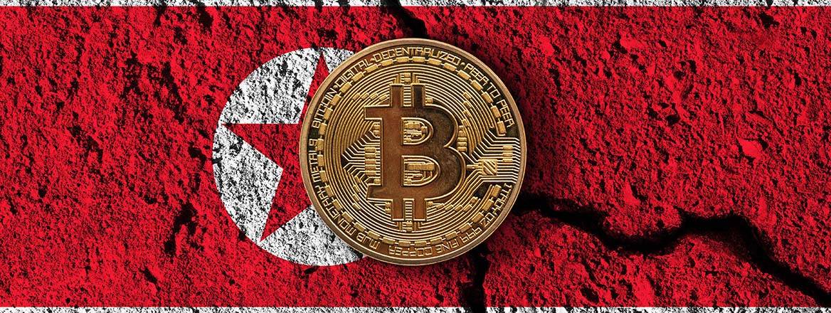 Bitcoin crypto currency coin with cracked North Korea flag.