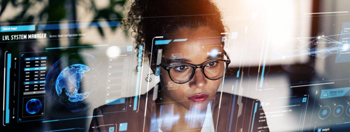 Woman working at computer with futuristic concept