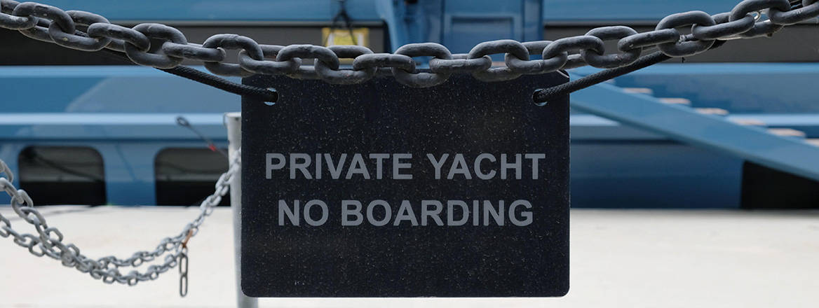Limited progress: a sign next to a superyacht in Canary Wharf, London, which was detained by UK authorities in March over the owner's links to Russia
