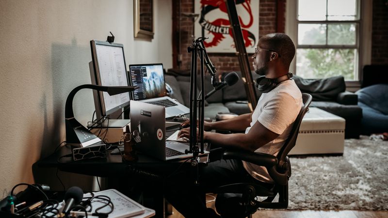 Guy recording a podcast on the computer