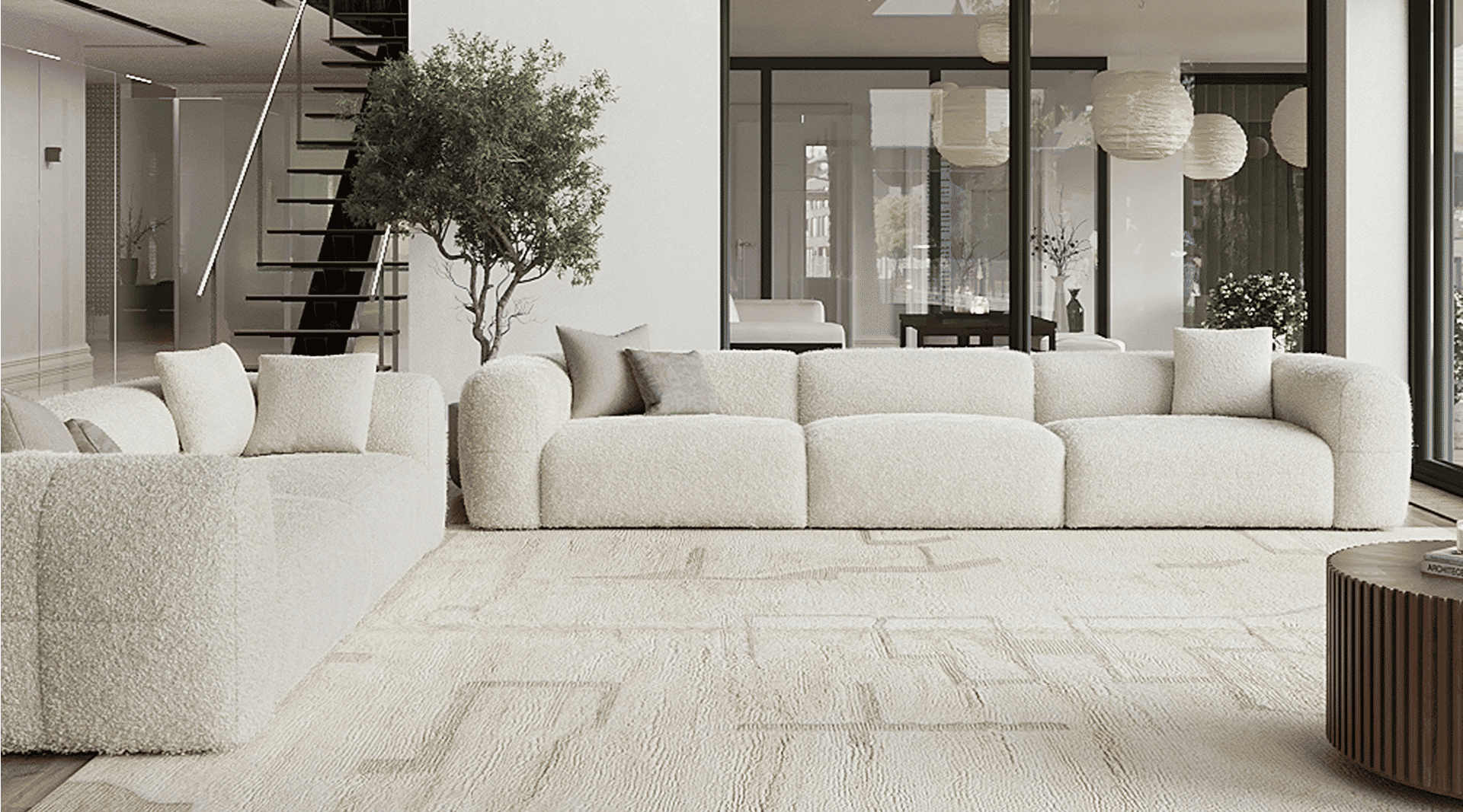 White boucle modular sofa set with low backs and plush cushions in a spacious modern living room with large windows, a staircase, and neutral decor.