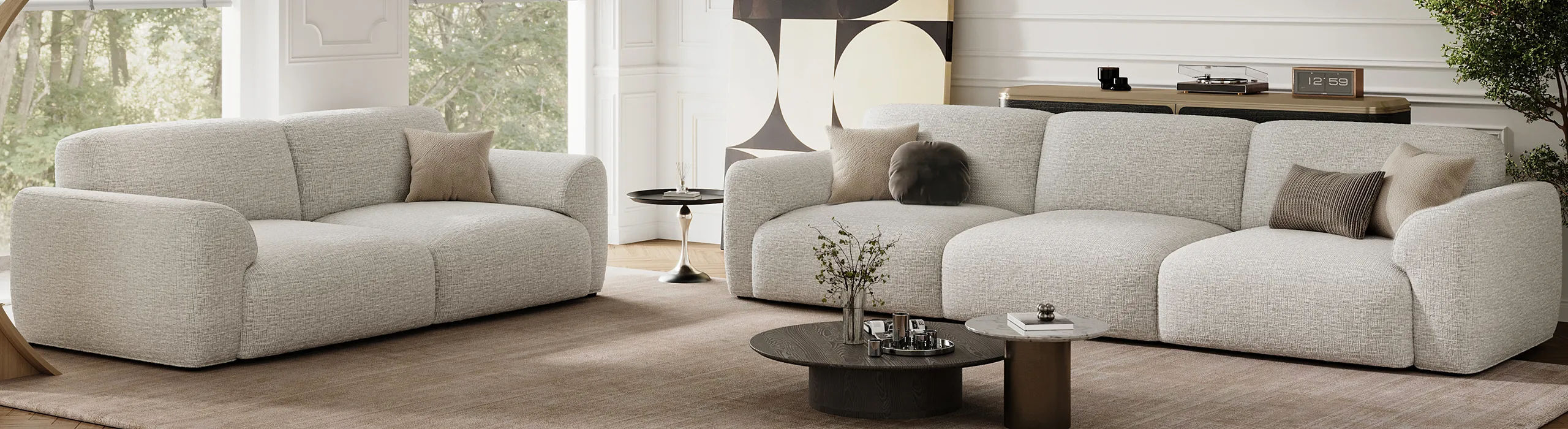 Light gray sofa and loveseat with rounded arms and deep cushions in a bright modern living room.