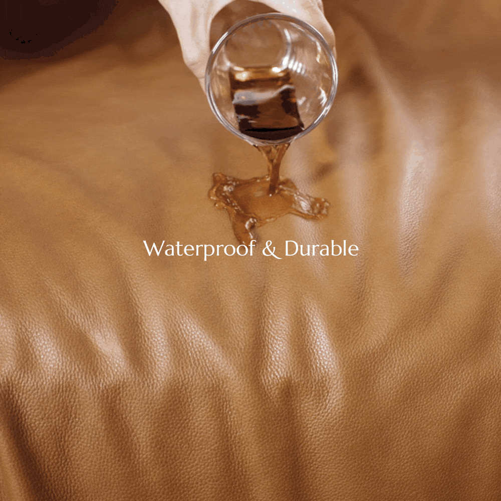 Liquid being poured onto the smooth surface of a leather upholstered sofa, demonstrating its water-repellent properties and effortless cleanup for busy living rooms.